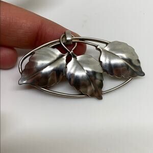Vintage silver toned three leaf brooch